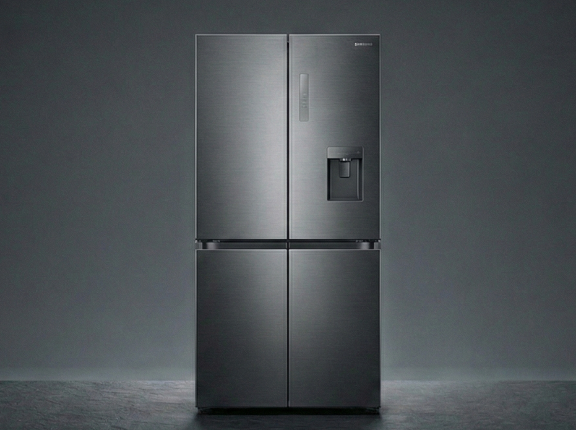 Modern stainless steel refrigerator on a dark gray background